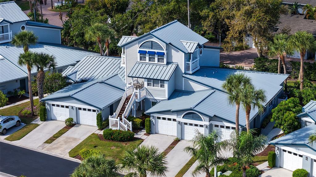 An aerial view of a multi-unit residential building with metal roofs and attached garages — 1225 SIESTA BAYSIDE DRIVE UNIT 1225B, SARASOTA, FL