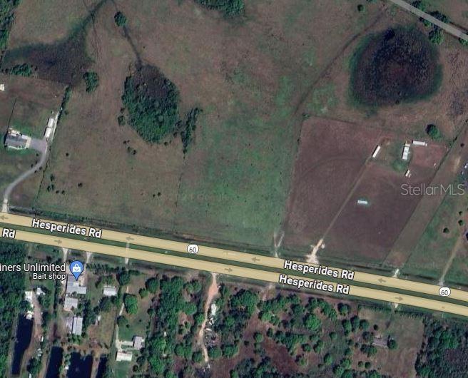 This is an aerial map view of a large, undeveloped grassy lot along a highway — 60 E STREET, LAKE WALES, FL