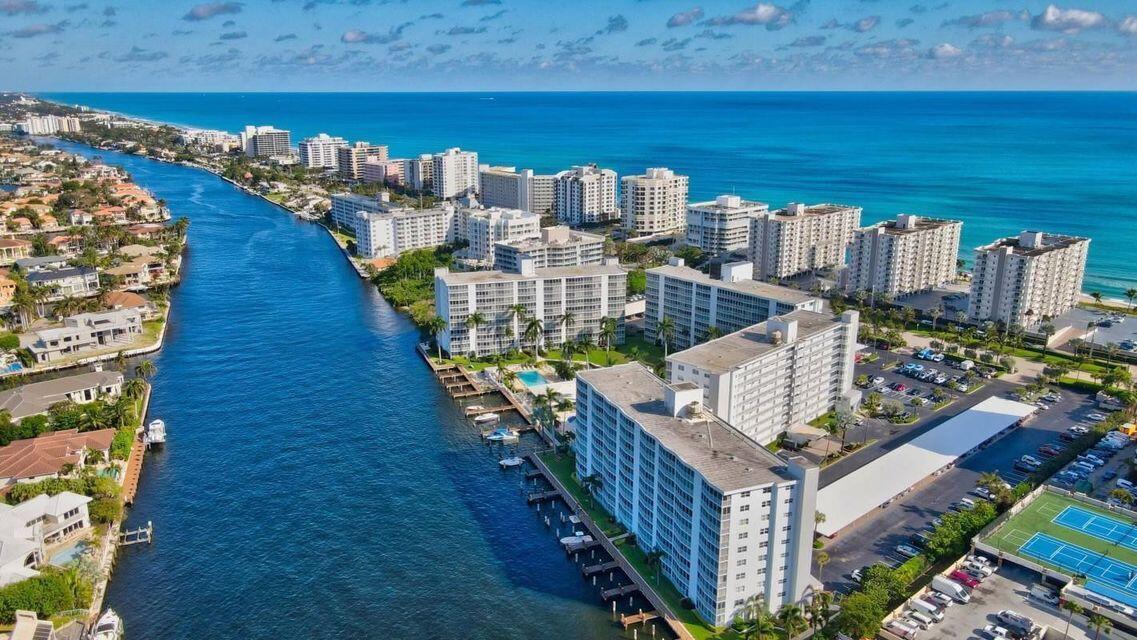 An aerial view of a canal lined with apartment buildings and a nearby ocean coastline — 3300 S Ocean Boulevard # c, Highland Beach FL 33487, HIGHLAND BEACH, FL
