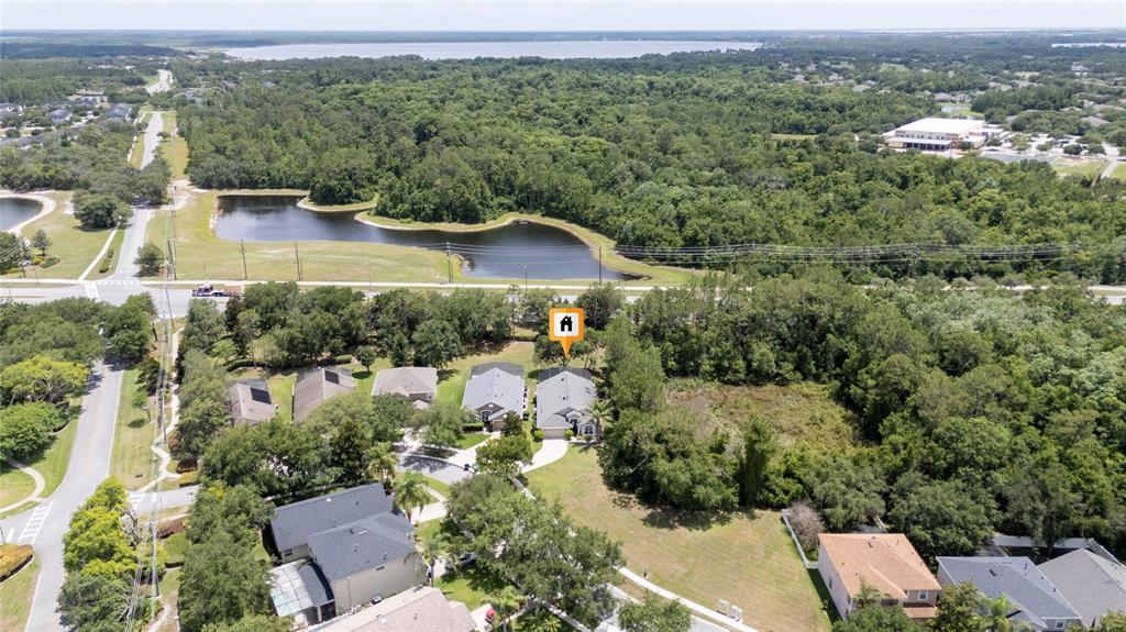 An aerial view shows a residential neighborhood with a house marked by an orange icon — 10966 ELIOTTI STREET, ORLANDO, FL
