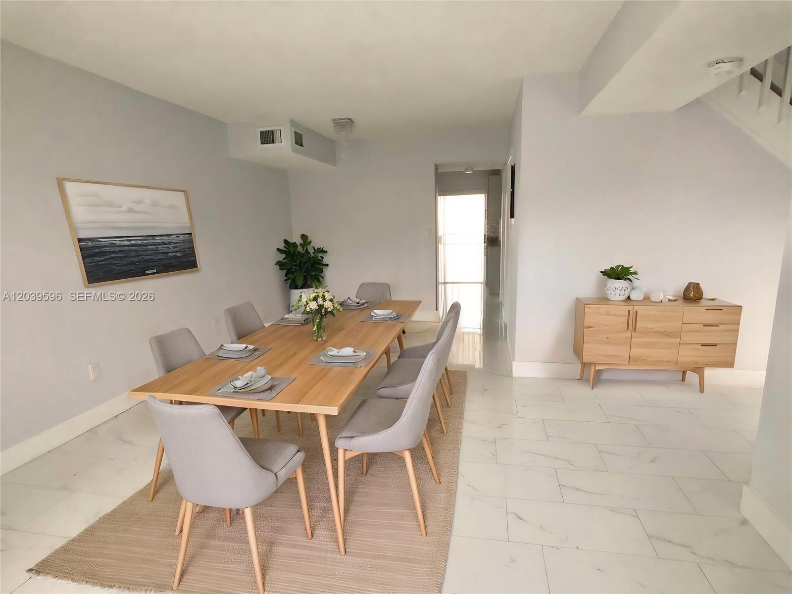 A dining room features a wooden table with six gray chairs on a rug — 7211 W 24th Ave # 2263, Hialeah FL 33016, HIALEAH, FL