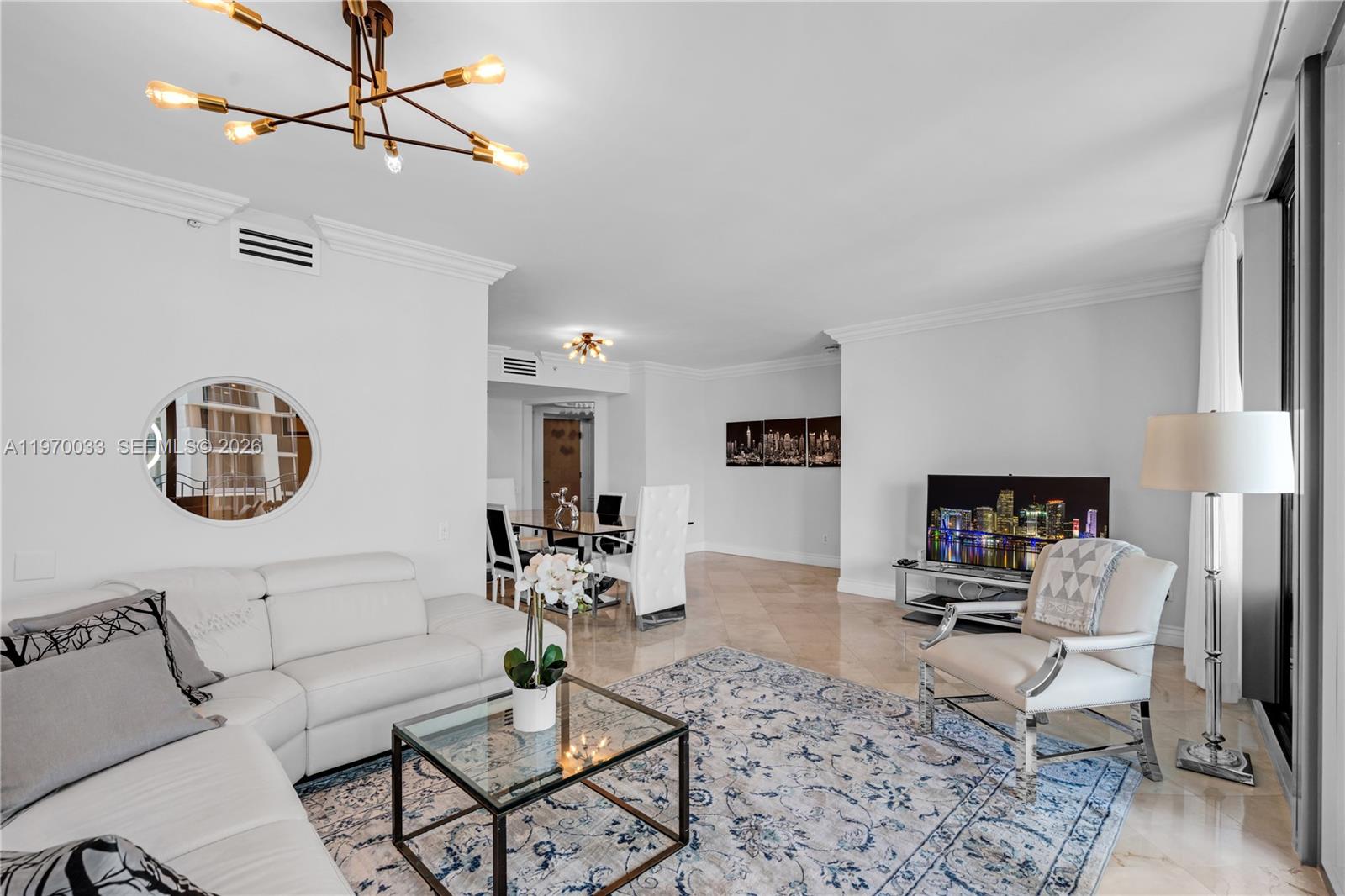 A bright living room features white leather furniture, a glass coffee table, and tile flooring — 1500 Ocean Dr # 704, Miami Beach FL 33139, MIAMI BEACH, FL