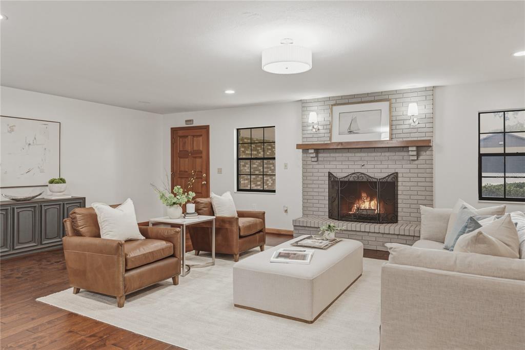 A living room features a brick fireplace, leather armchairs, a light-colored sofa, and hardwood floors — 236 PINELLAS STREET, LAKELAND, FL