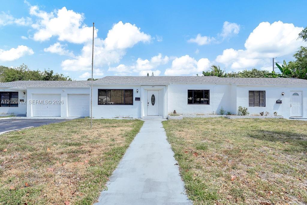 A single-story white house with a gray roof, a front walkway, and a garage — 2417 Pierce St, Hollywood FL 33020, HOLLYWOOD, FL
