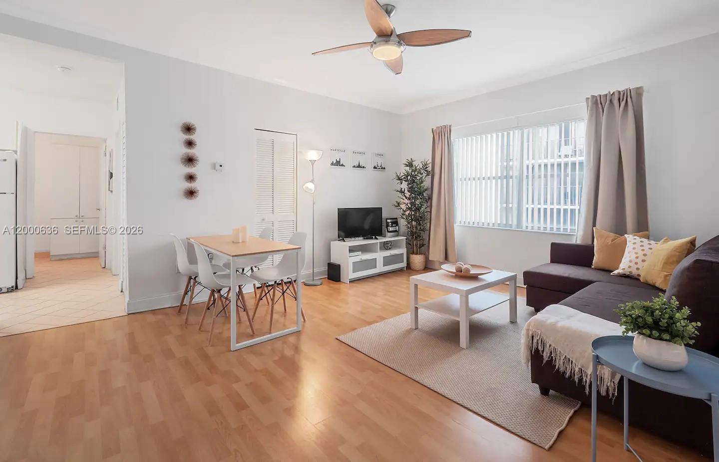 A living and dining area features light wood flooring, a ceiling fan, and neutral furniture — 2615 Collins Ave # 37, Miami Beach FL 33140, MIAMI BEACH, FL