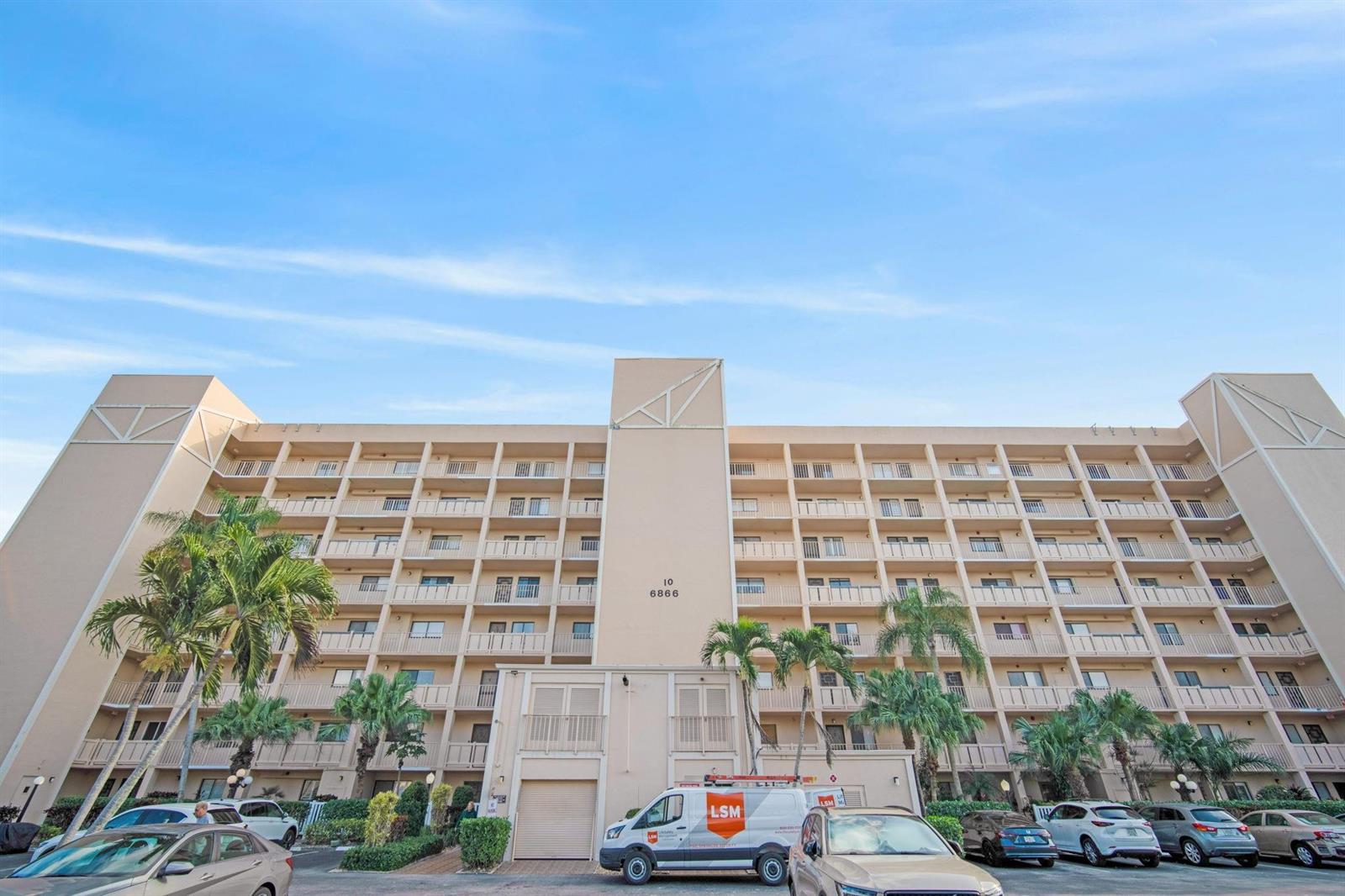 A multi-story apartment building with balconies and a parking lot in front — 6866 Huntington Lane # 304, Delray Beach FL 33446, DELRAY BEACH, FL