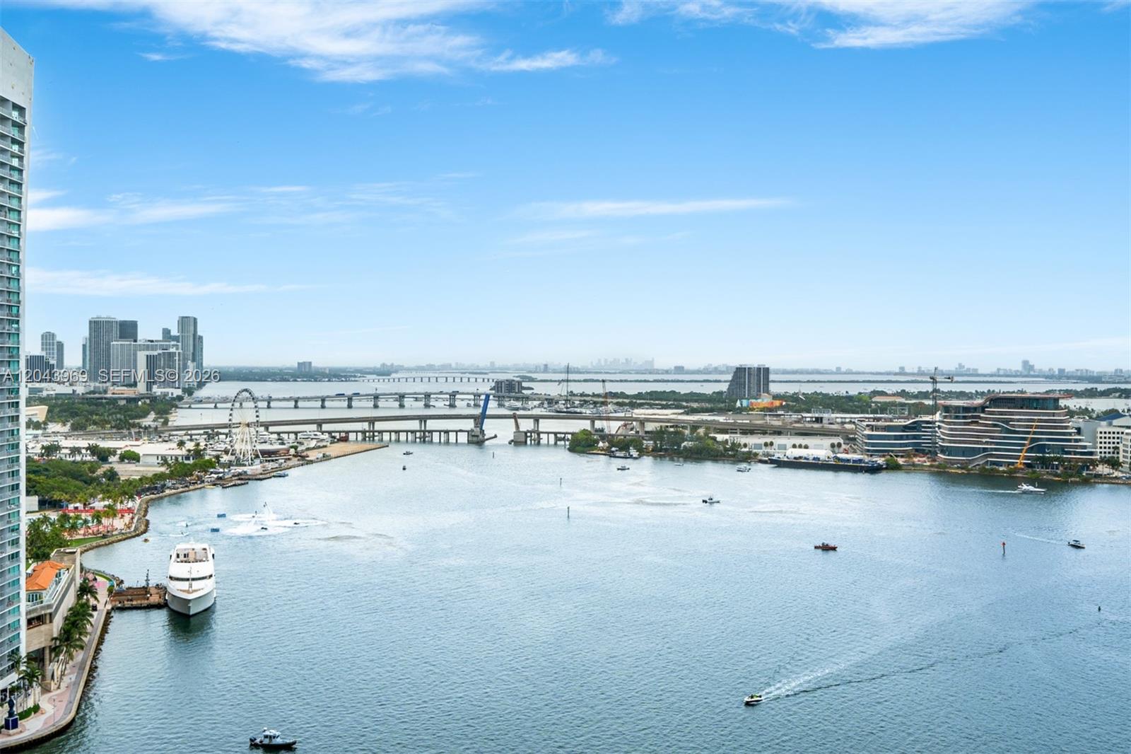 An elevated view shows a bay with boats, a bridge, and city buildings in the distance — 888 Brickell Key Dr # 2610, Miami FL 33131, MIAMI, FL