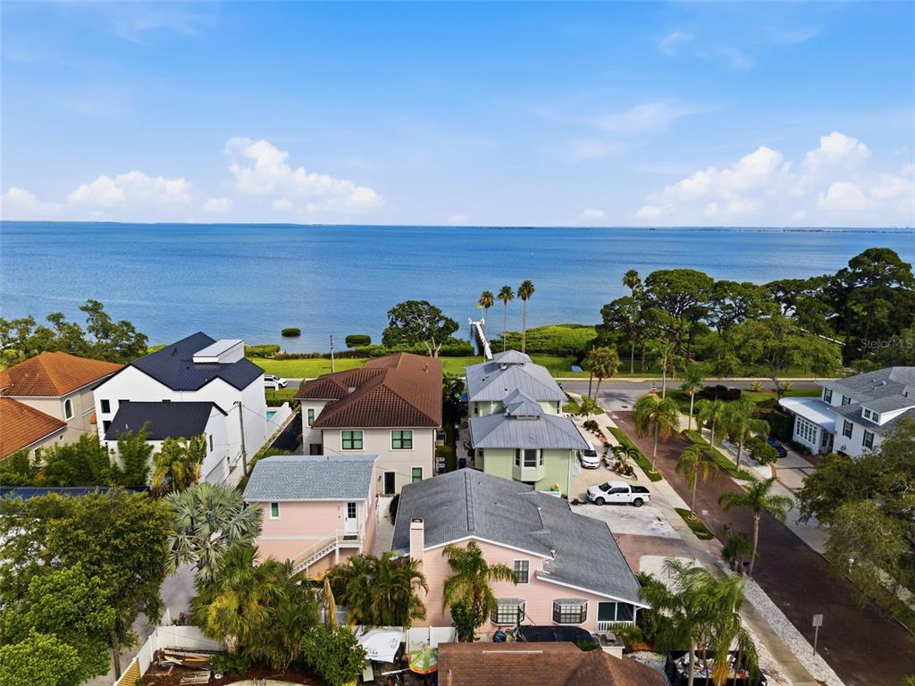 An aerial view shows several waterfront houses with palm trees and a dock nearby — 345 BAILEY STREET, SAFETY HARBOR, FL