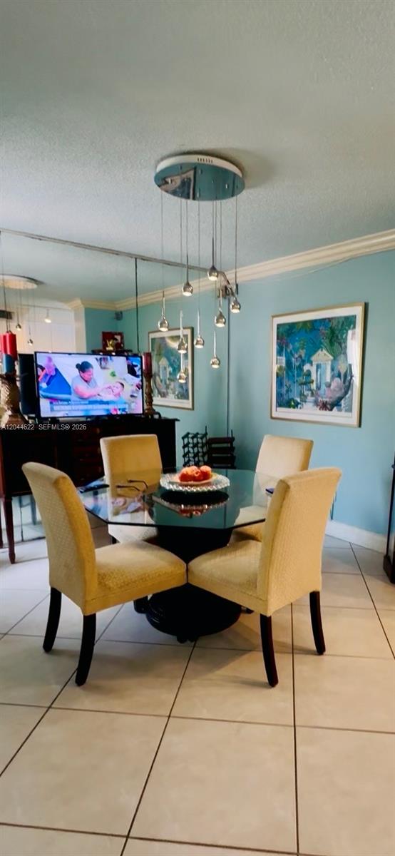 A living room features light blue walls, wood-look flooring, two striped armchairs, and a television — 635 NW 97th Pl, Miami FL 33172, MIAMI, FL