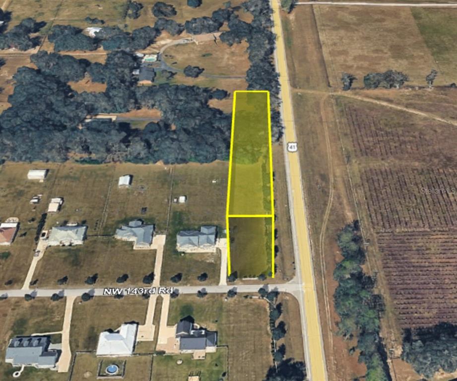 An aerial view shows a rectangular, highlighted vacant lot bordering a road and residential area — 0 NW 143RD ROAD, HIGH SPRINGS, FL