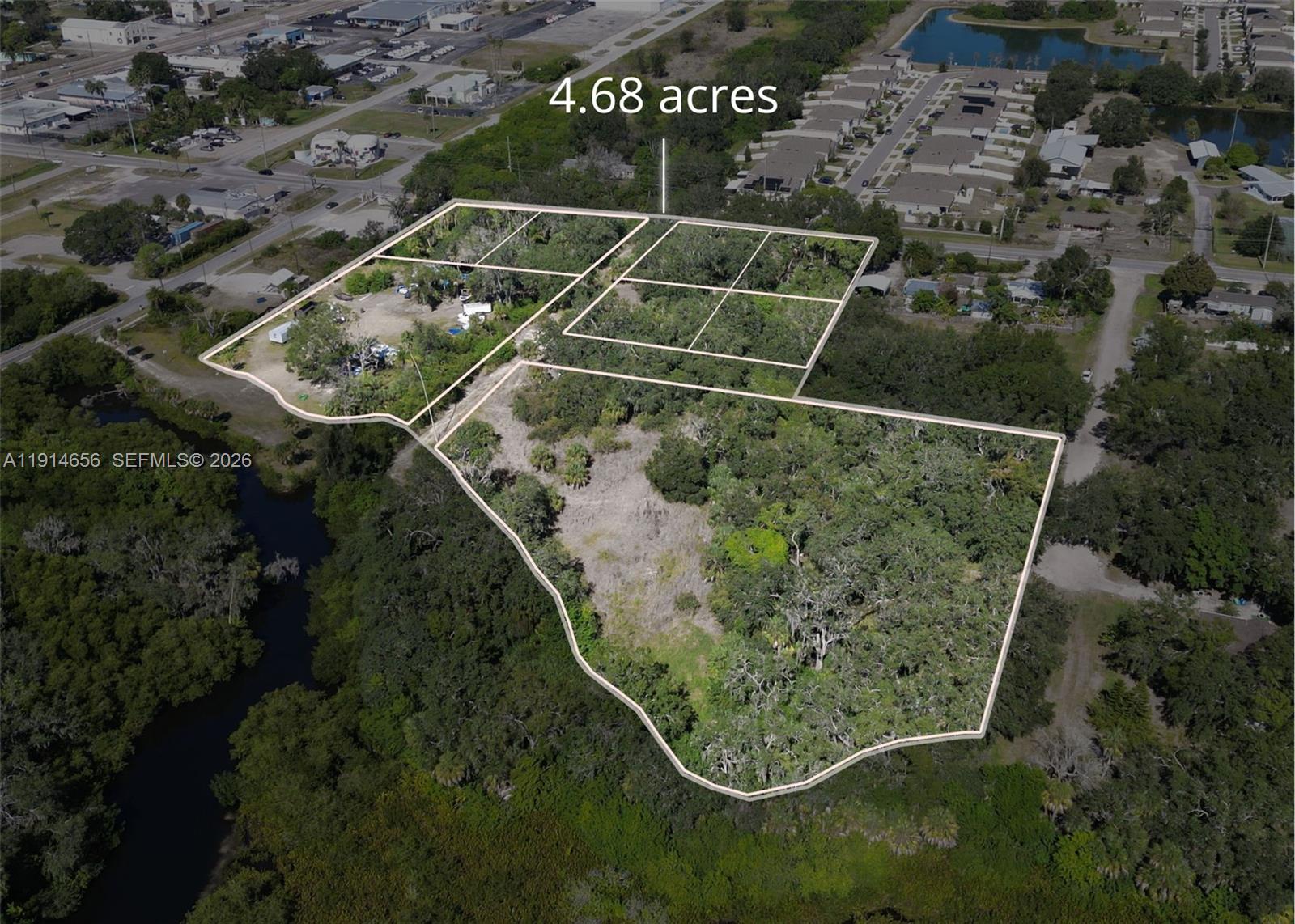An aerial view shows a large, undeveloped parcel of land outlined in white — 301 E Shell Point Road, Tampa FL 33570, TAMPA, FL