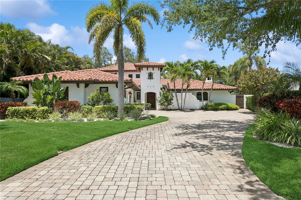 A white stucco house with a red tile roof and a paved driveway — 145 BAY POINT DRIVE NE, ST PETERSBURG, FL