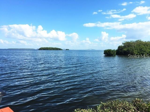 A view of a calm bay with small islands under a blue sky with clouds — 1515 PINELLAS BAYWAY S UNIT 15, TIERRA VERDE, FL