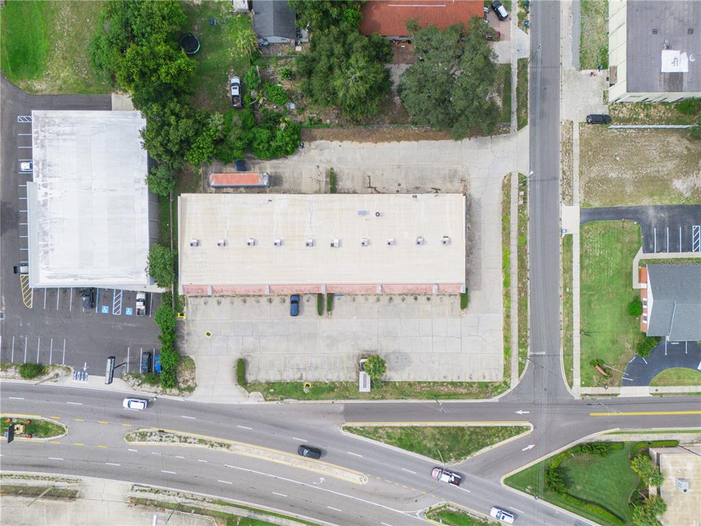 An aerial view shows a commercial building with a large parking lot and surrounding roads — 104 STATE ROAD 60 W, LAKE WALES, FL