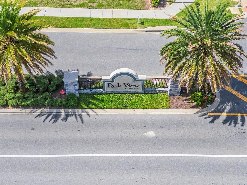 An aerial view shows the entrance sign for Park View at the Hills community — 864 VINEYARD RIDGE ROAD, MINNEOLA, FL