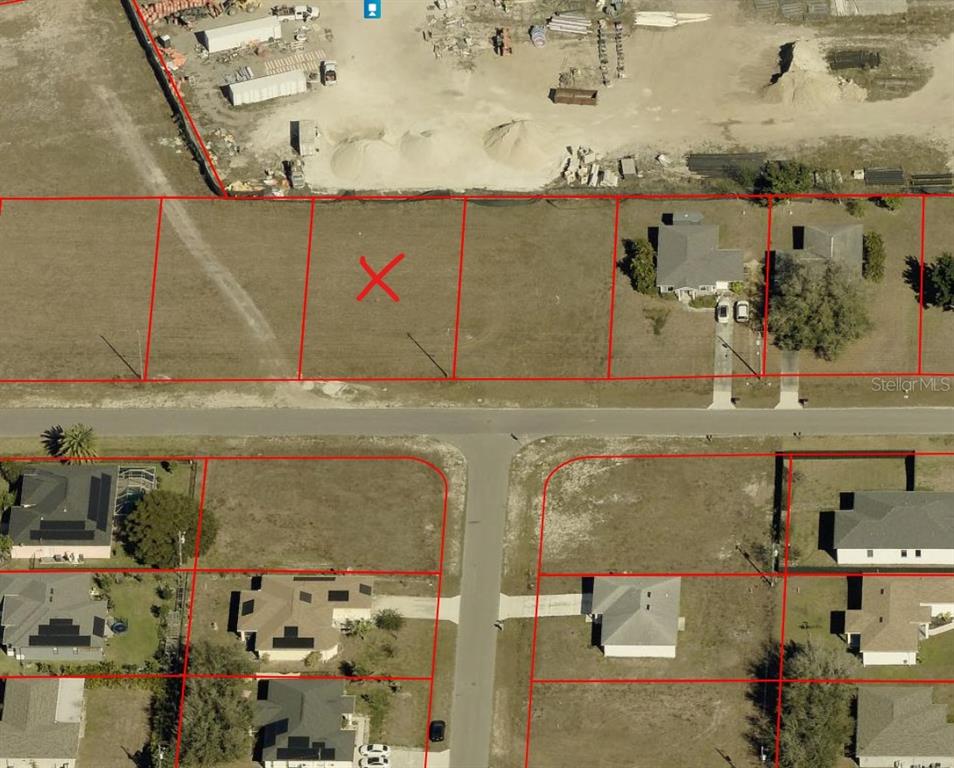 An aerial map shows a vacant residential lot marked with an X among developed properties — 623 NE 15TH TERRACE, CAPE CORAL, FL