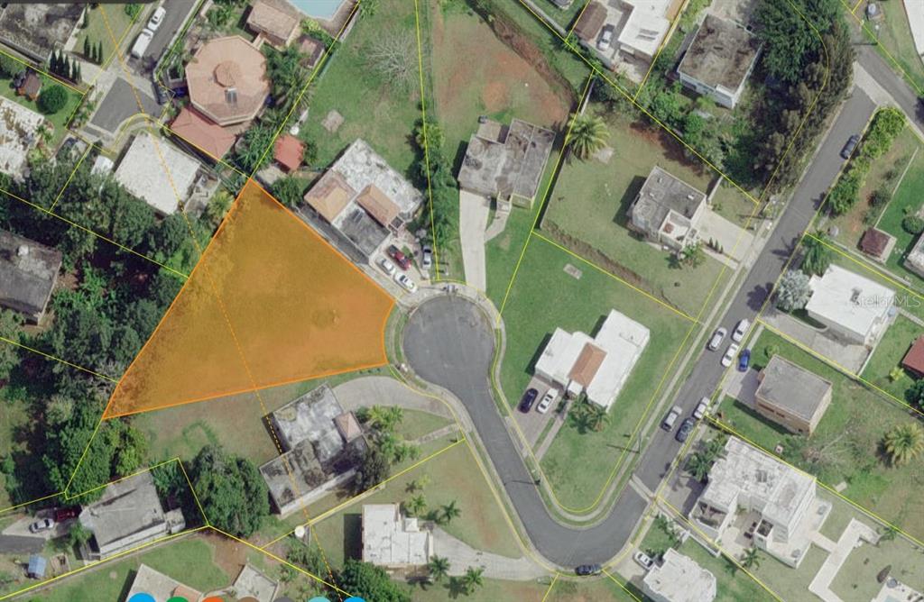 This aerial map shows a vacant, triangular-shaped residential lot highlighted in orange within a neighborhood — CANABONCITO STRD 172 KM7.5, CAGUAS, PR