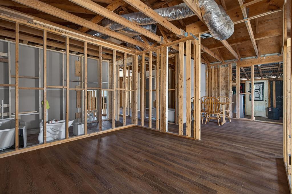 An interior view of a room under construction with exposed wooden wall studs and flooring — 7610 E SPANISH TRAIL, FLORAL CITY, FL