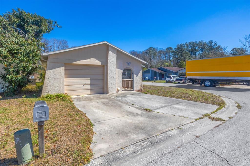 A single-story house with a garage, concrete driveway, and a mailbox in the front yard — 12622 TIMBERWOOD COURT, HUDSON, FL
