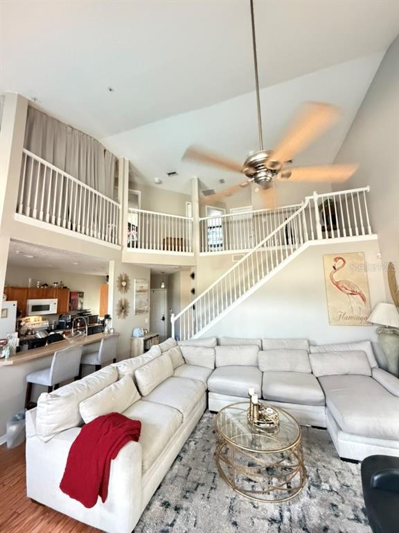 A living room with a sectional sofa, a lofted area, and an open kitchen — 673 SANDY NECK LANE UNIT 201, ALTAMONTE SPRINGS, FL