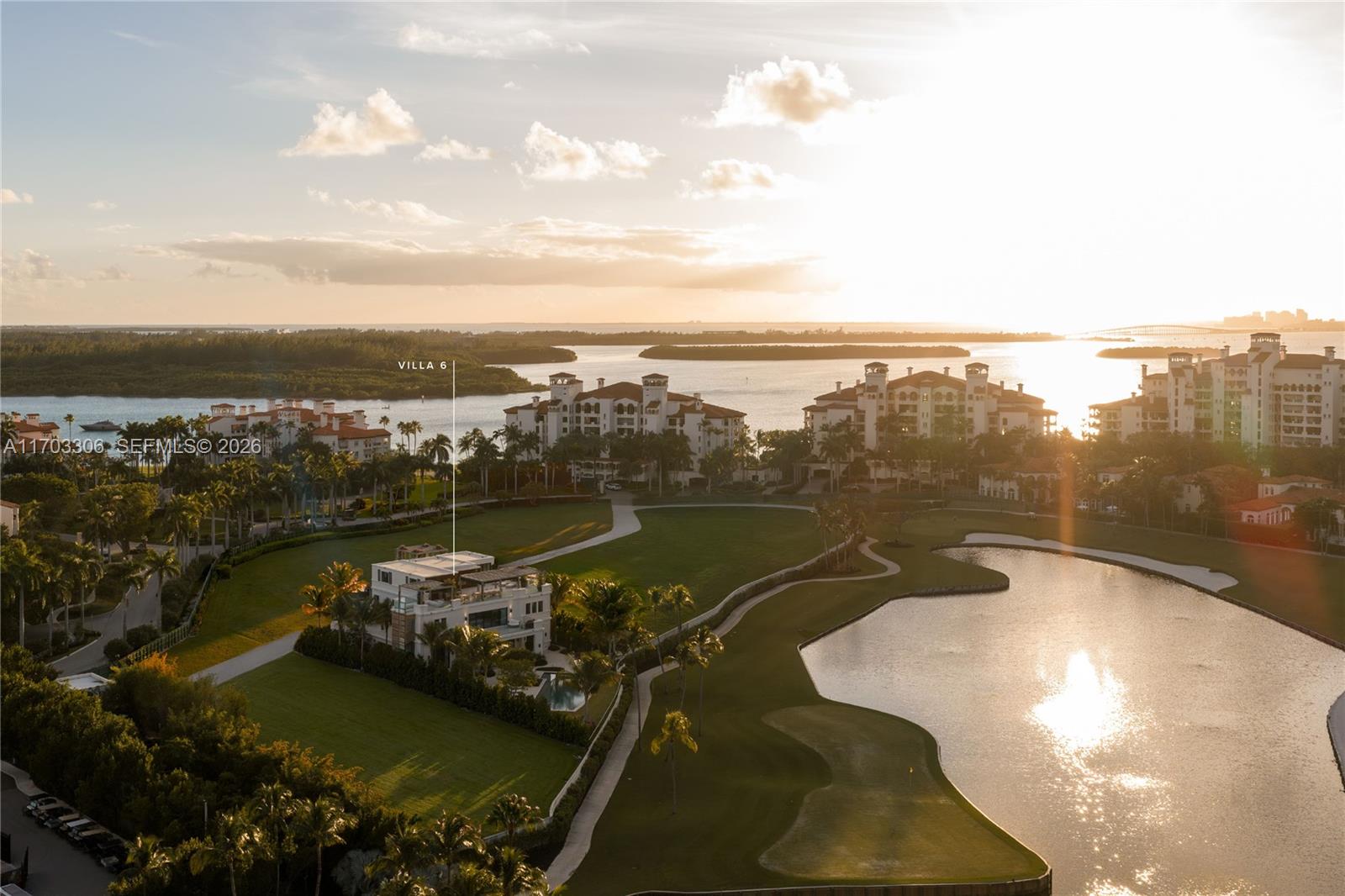 An aerial view shows a villa situated on a golf course near a large body of water — 1006 Links Drive, Miami Beach FL 33109, MIAMI BEACH, FL