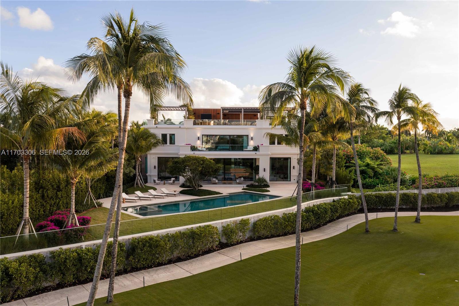 A three-story white house with a swimming pool, palm trees, and a landscaped lawn — 1006 Links Drive, Miami Beach FL 33109, MIAMI BEACH, FL