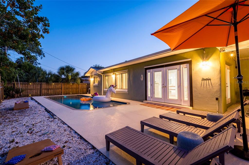 A single-story house with green siding, a white roof, and a gravel front yard — 955 INDIAN ROCKS ROAD S, LARGO, FL