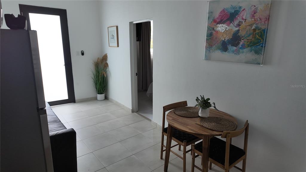 A dining area with a small wooden table and chairs sits near a doorway — 73 CALLE TAPIA UNIT 2, SAN JUAN, PR