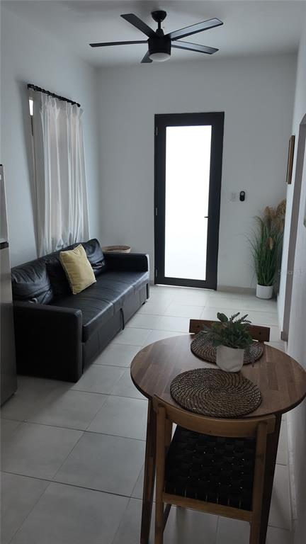 A small living and dining area features a black sofa, round wooden table, and ceiling fan — 73 CALLE TAPIA UNIT 2, SAN JUAN, PR