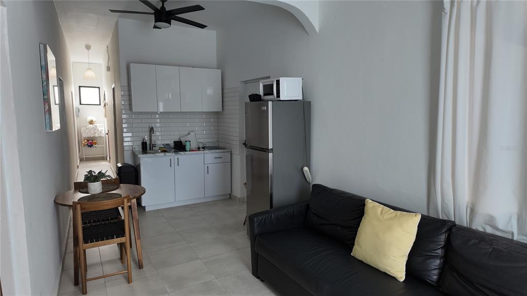 A small studio apartment features a kitchenette, a dining table, and a black sofa — 73 CALLE TAPIA UNIT 2, SAN JUAN, PR