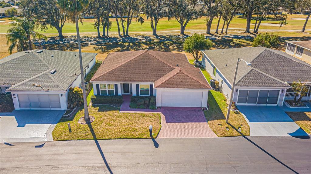 A living room features light wood floors, a sectional sofa, and a large television — 29140 PRINCEVILLE DRIVE, SAN ANTONIO, FL