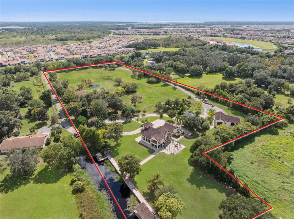 An aerial view shows a large house and detached garage on a sprawling, tree-lined property — 11205 TINDALL ROAD, ORLANDO, FL
