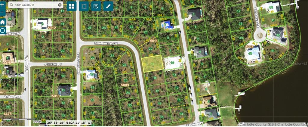 This is a satellite map showing a vacant residential lot highlighted in yellow — 9829 SHELBURNE CIRCLE, PORT CHARLOTTE, FL