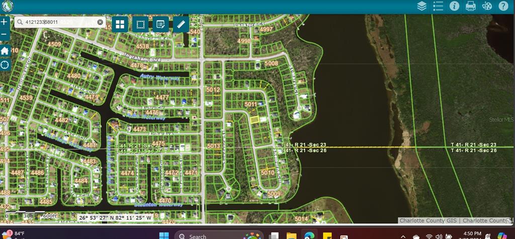 This is a digital map showing residential lots and waterways in a Charlotte County neighborhood — 9829 SHELBURNE CIRCLE, PORT CHARLOTTE, FL