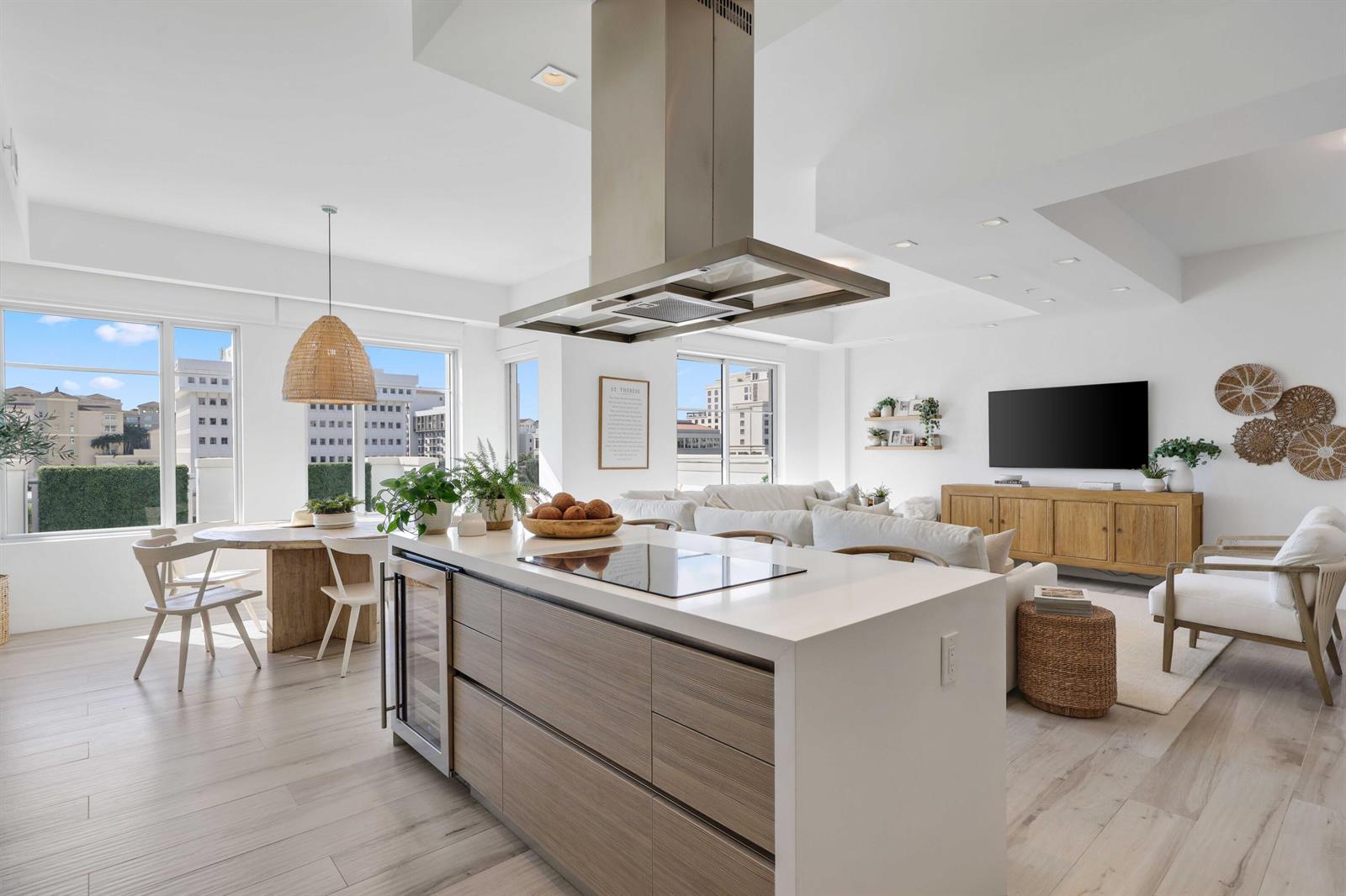 A modern open-concept kitchen and living area features a large island and light wood flooring — 155 E Boca Raton Road # 601, Boca Raton FL 33432, BOCA RATON, FL