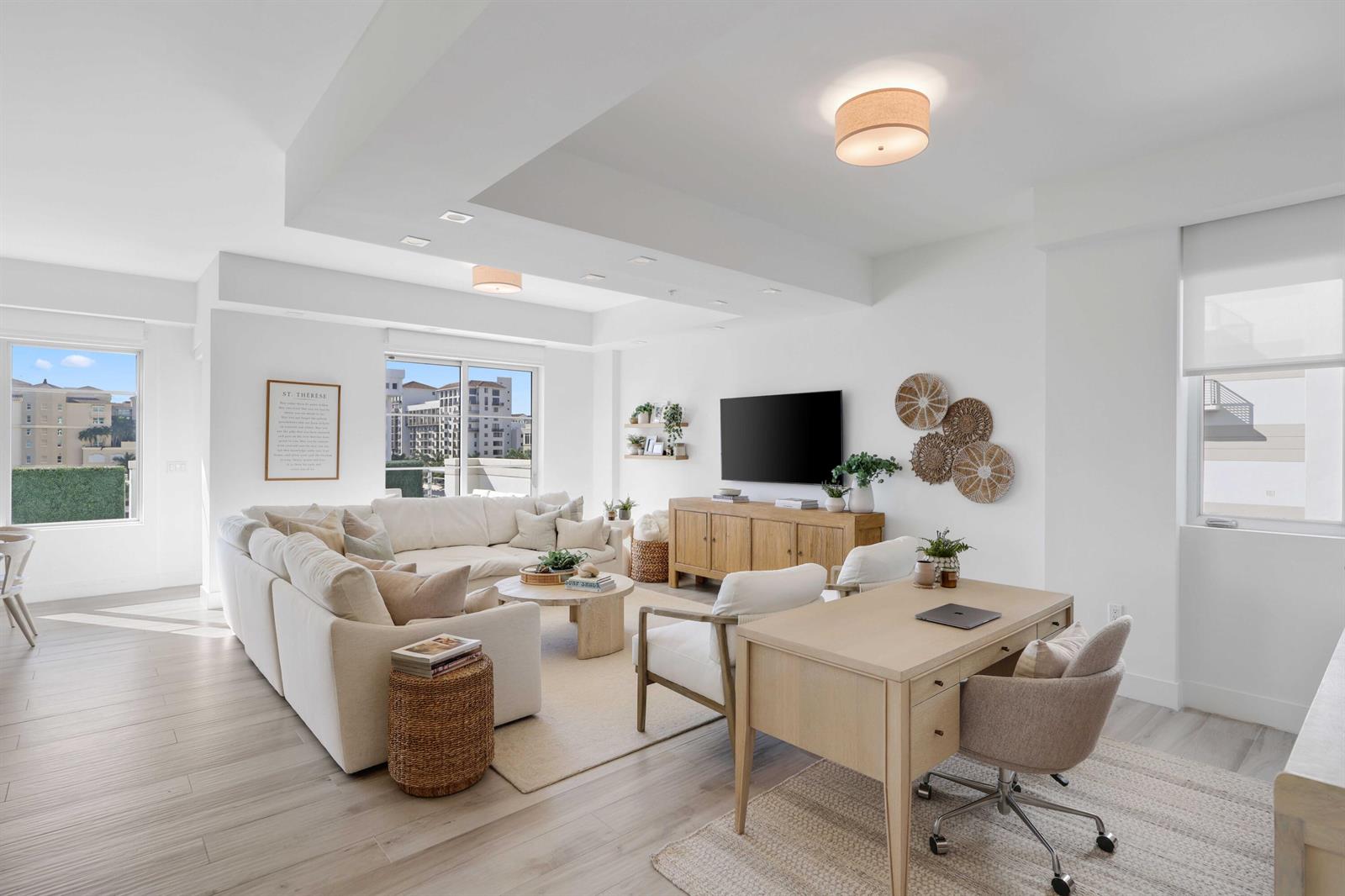 A bright living room features a white sectional sofa, a wooden desk, and large windows — 155 E Boca Raton Road # 601, Boca Raton FL 33432, BOCA RATON, FL