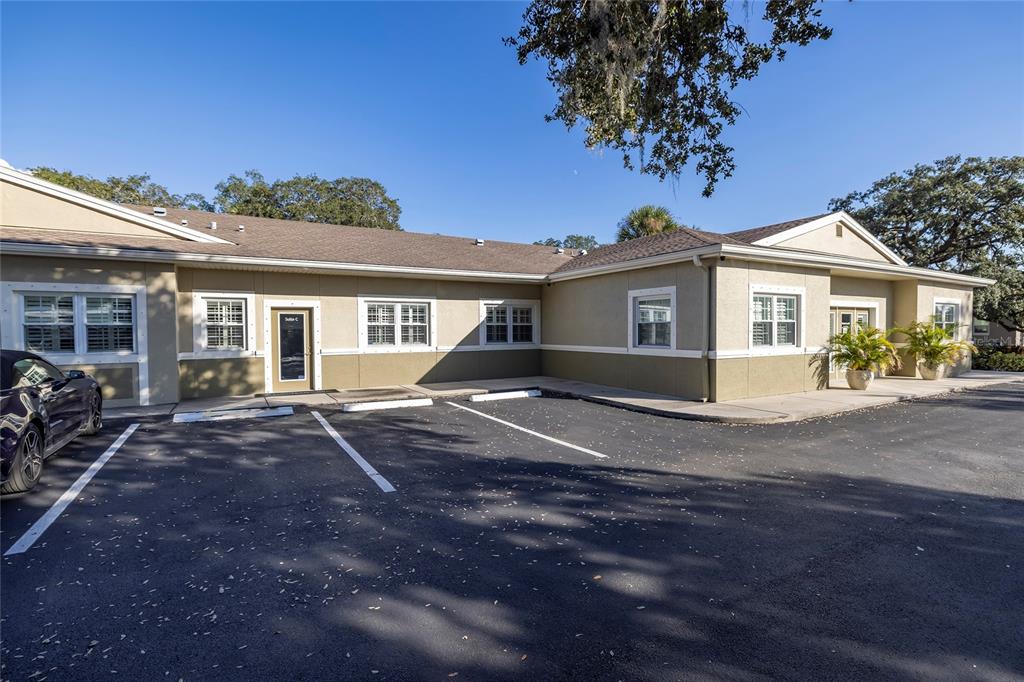 A single-story commercial building with tan siding and a parking lot in front — 801 2ND STREET N UNIT C, SAFETY HARBOR, FL