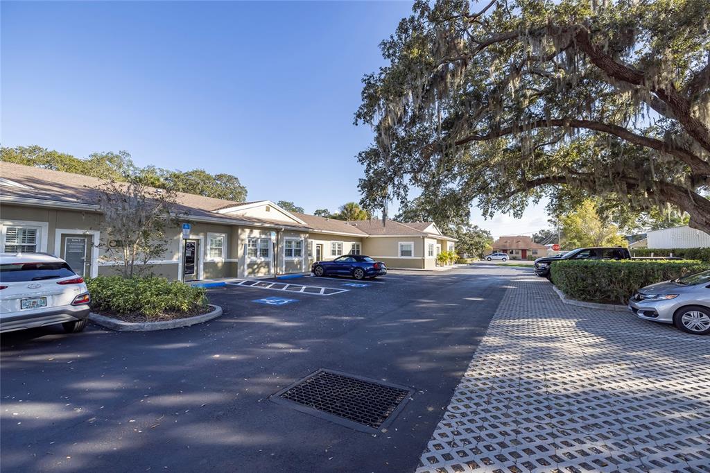A single-story commercial building with a parking lot and large oak trees — 801 2ND STREET N UNIT C, SAFETY HARBOR, FL