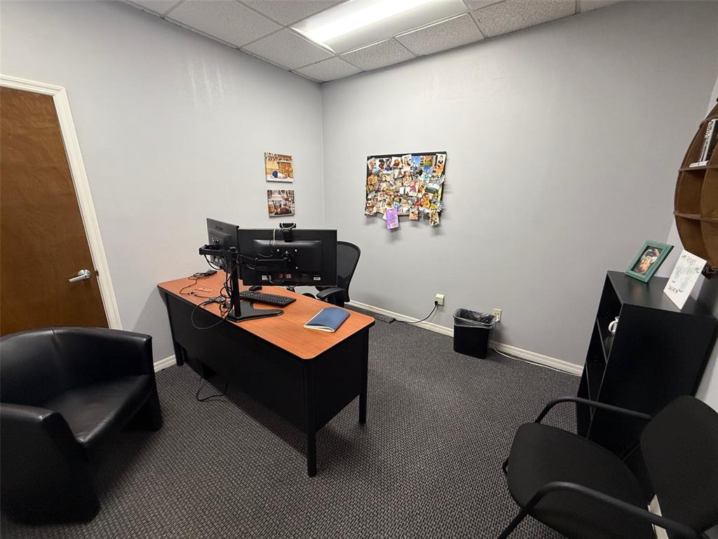 A small office features a desk with dual monitors, two chairs, and a bulletin board — 2841 EXECUTIVE DRIVE UNIT 200, CLEARWATER, FL