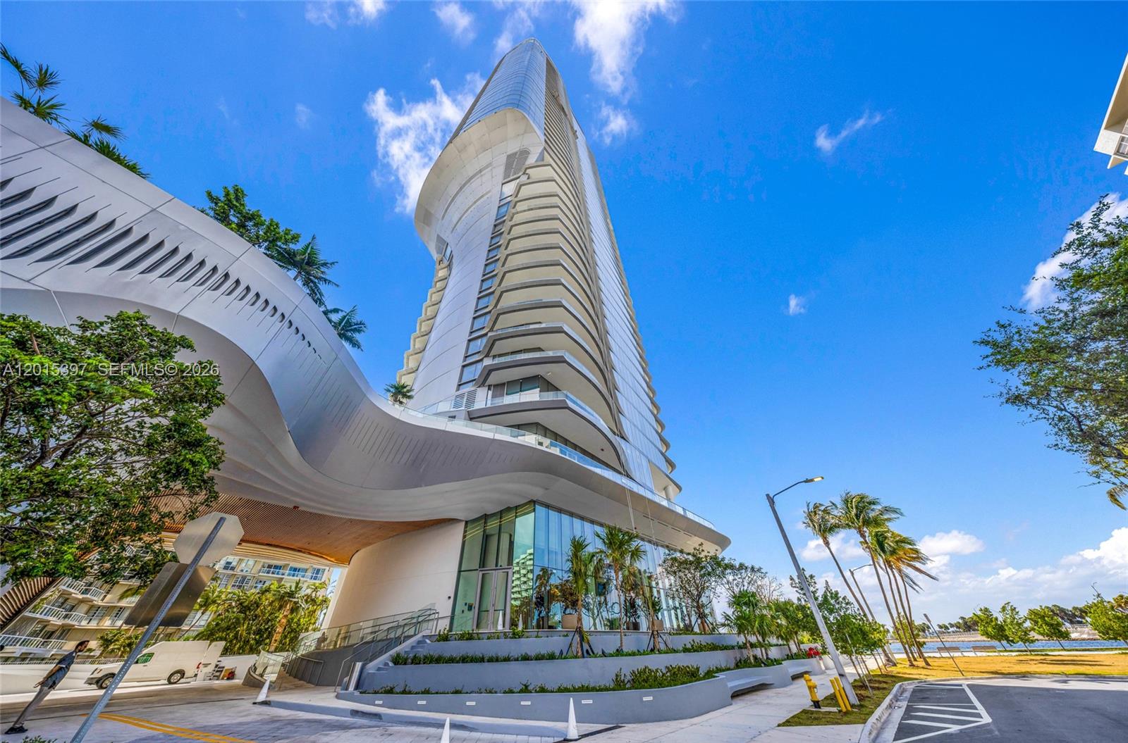 A modern high-rise building with a curved, cantilevered white structure and glass facade — 175 SE 25 Road # 1203, Miami FL 33129, MIAMI, FL