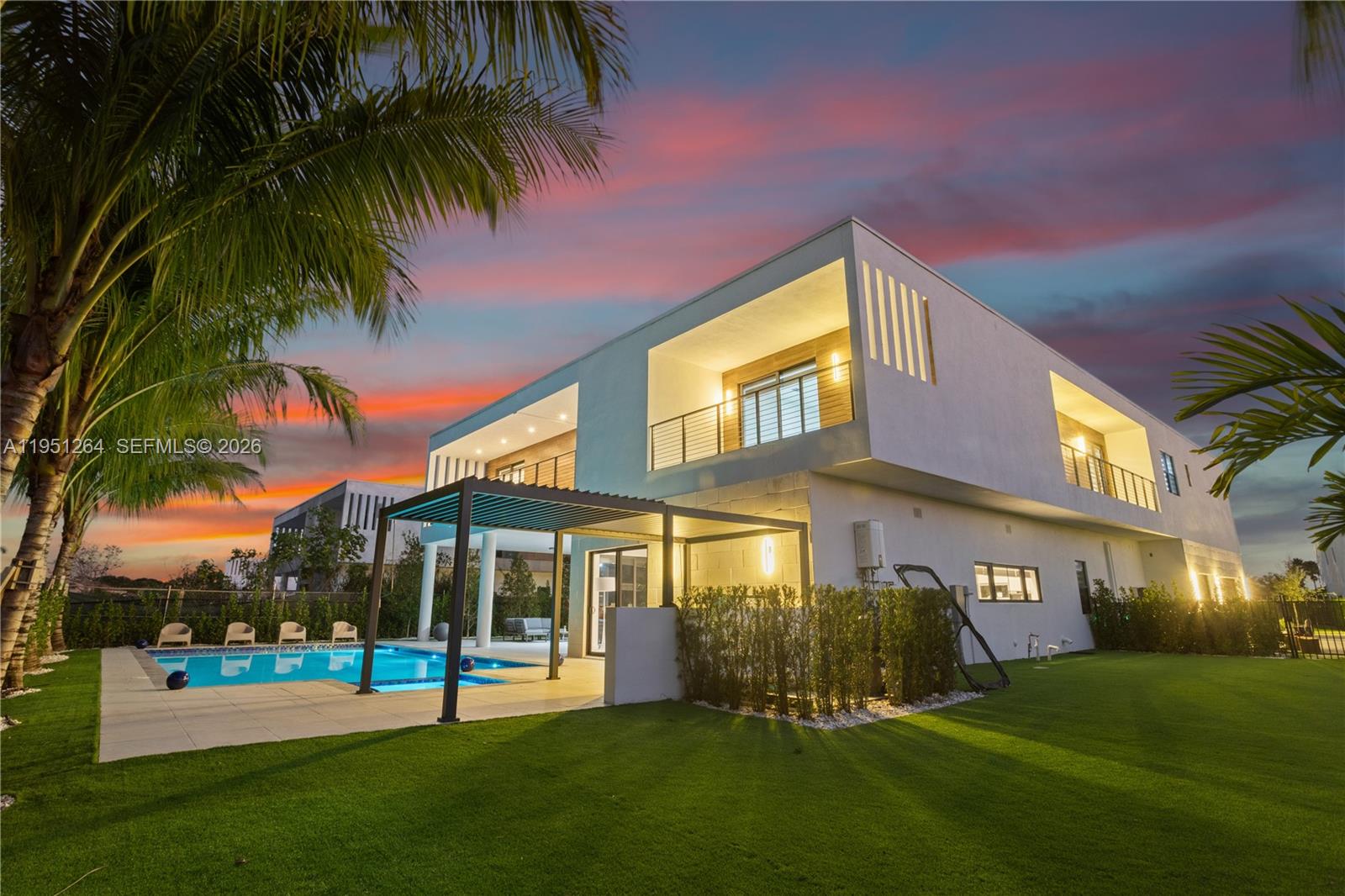 A modern two-story house with a swimming pool, patio, and palm trees at sunset — 16773 S Botaniko Dr S, Weston FL 33326, WESTON, FL