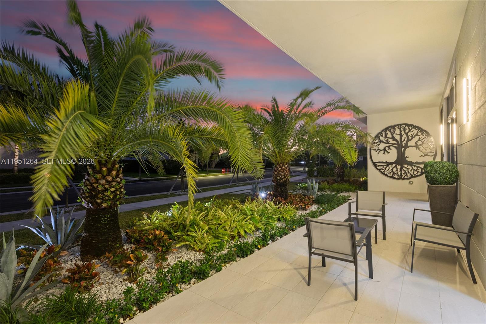 A covered patio features outdoor seating, palm trees, and a decorative tree wall art piece — 16773 S Botaniko Dr S, Weston FL 33326, WESTON, FL