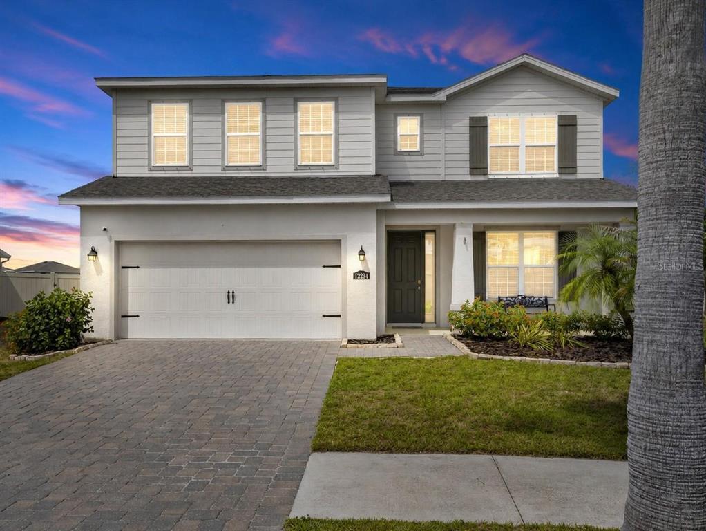 A two-story house with a gray exterior, a two-car garage, and a paved driveway — 12234 BLUE PACIFIC DRIVE, RIVERVIEW, FL