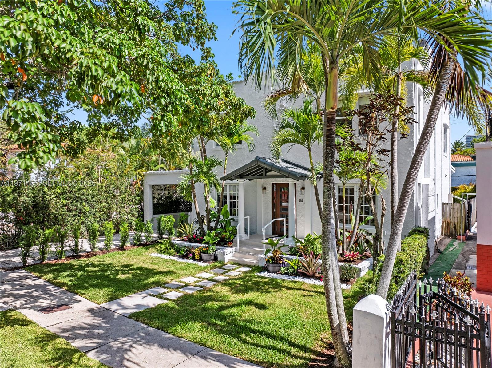 A two-story white house features a front porch, palm trees, and a landscaped yard — 178 NE 45th St, Miami FL 33137, MIAMI, FL