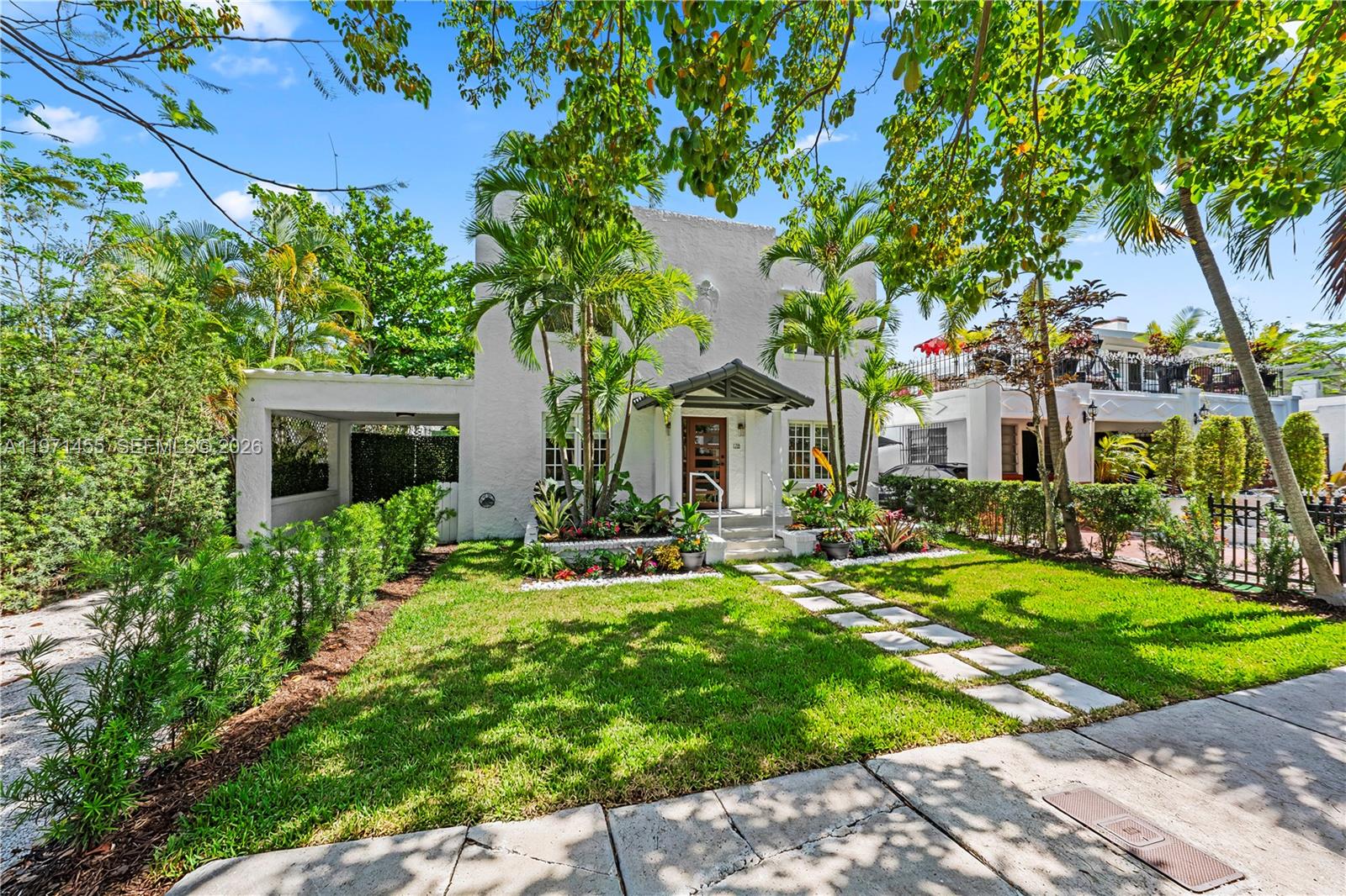 A two-story white stucco house features a front porch, palm trees, and a paved walkway — 178 NE 45th St, Miami FL 33137, MIAMI, FL