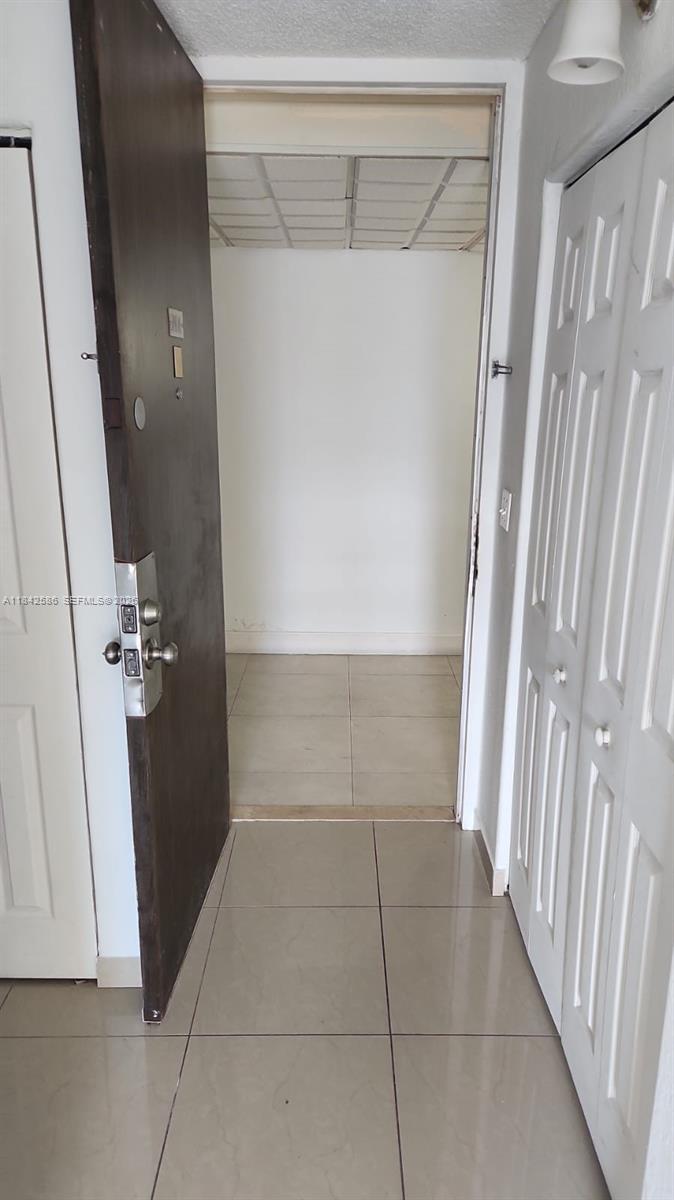 A tiled entryway leads through an open doorway into a small, empty room — 16450 NW 2nd Ave # 206, Miami FL 33169, MIAMI, FL
