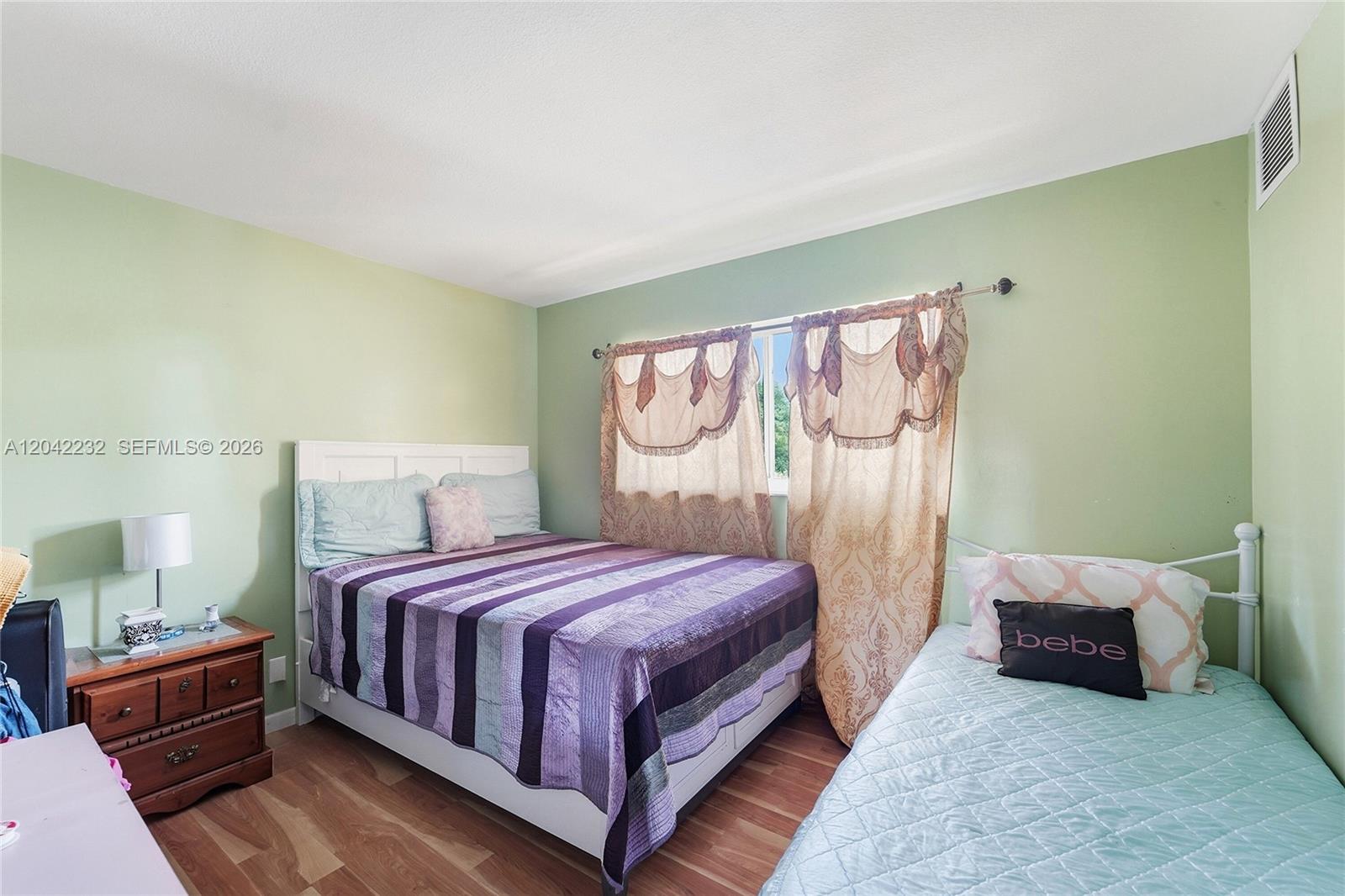 A bedroom features a queen bed, a twin bed, and light green walls — 2974 NW 55th Ave # 2B, Lauderhill FL 33313, LAUDERHILL, FL