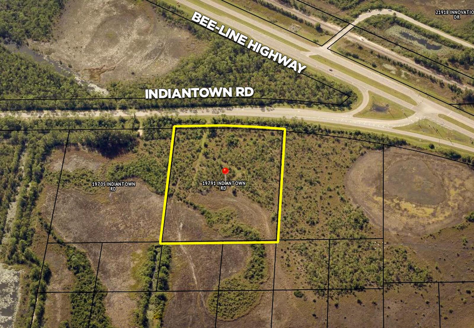 This aerial map shows a vacant, wooded lot outlined in yellow near a highway intersection — 19791 Indiantown Road, Jupiter FL 33478, JUPITER, FL