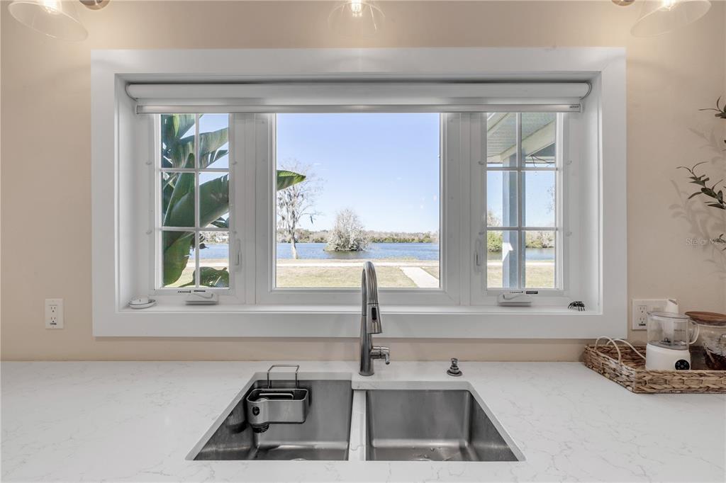 A kitchen sink with a view of a lake through a large window — 2760 PEARL LAKE TRAIL, NEW SMYRNA BEACH, FL