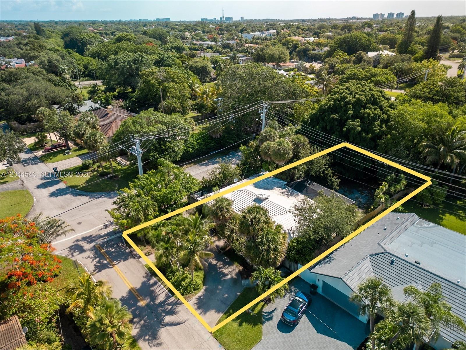An aerial view shows a single-story house with a white roof surrounded by lush trees — 698 NW 7th Ave, Boca Raton FL 33486, BOCA RATON, FL